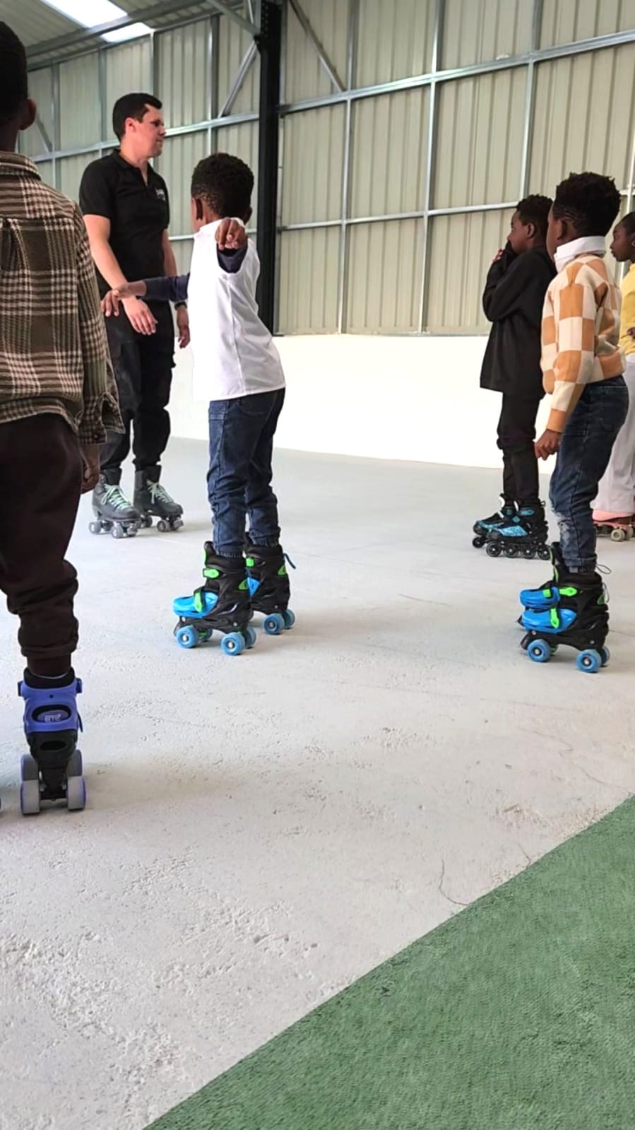 Coach teaching a skating lesson at Da Rolly
