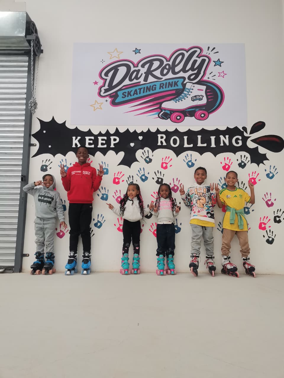 Group of young skaters at the Keep Rolling wall